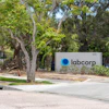 Labcorp corporate sign at building entrance with mature trees and landscaping