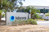 Labcorp building entrance sign with blue circular logo at corporate facility