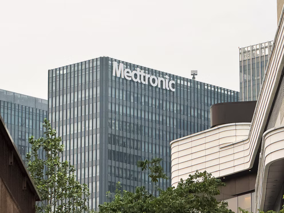 Medtronic corporate office building with white signage on gray facade, surrounded by modern architecture