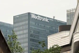 Medtronic corporate office building with white signage on gray facade, surrounded by modern architecture