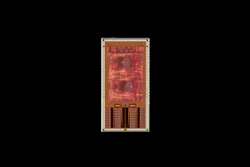 Red and gold circuit board design with geometric patterns and component layout