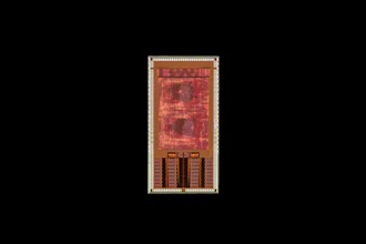 Red and gold circuit board design with geometric patterns and component layout