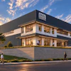 Modern NED corporate facility at golden hour with landscaping and parking area