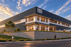 Modern NED corporate facility at golden hour with landscaping and parking area