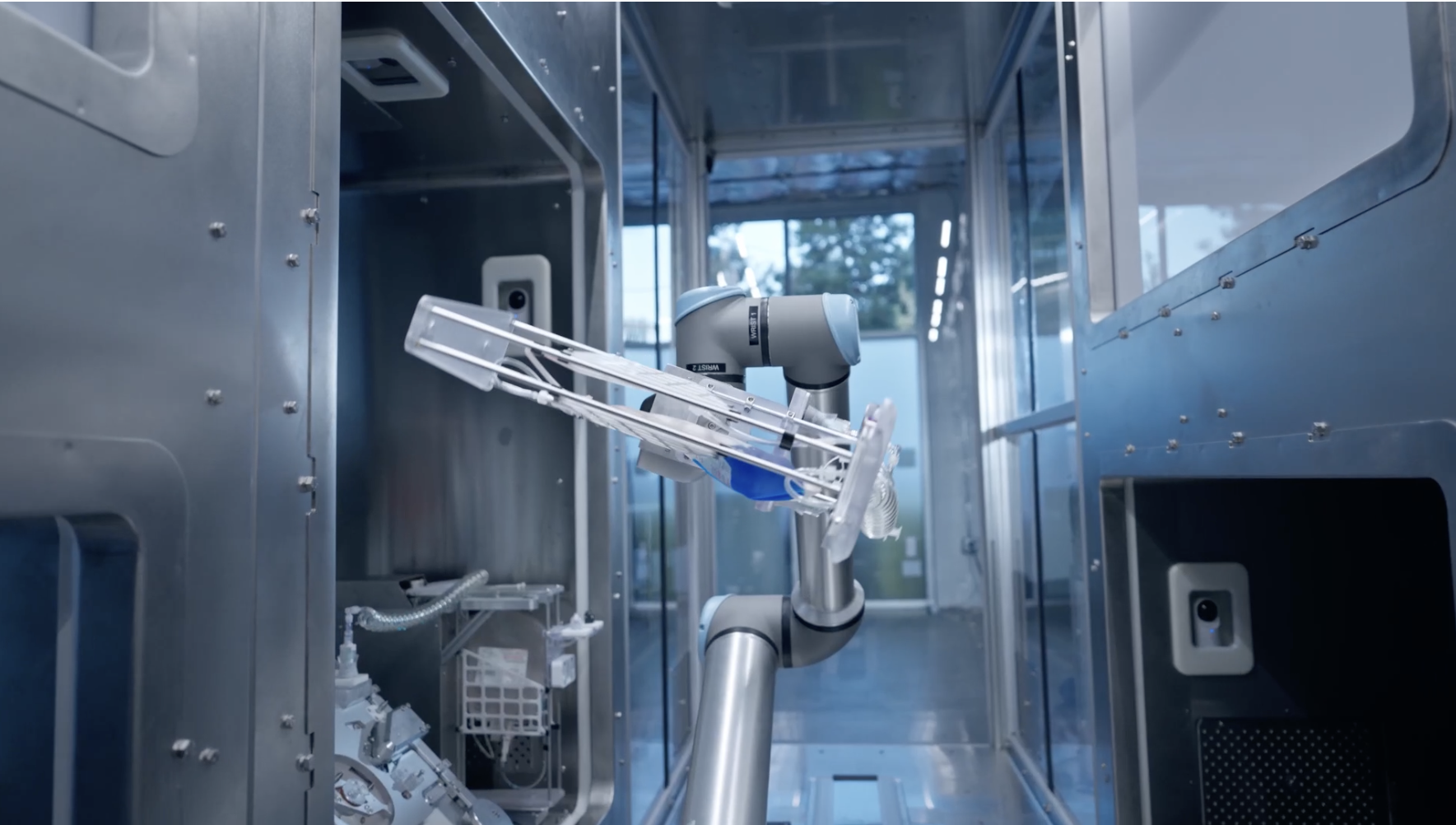 Interior view of robotic medical device with mechanical arm, tubing, and electronic components