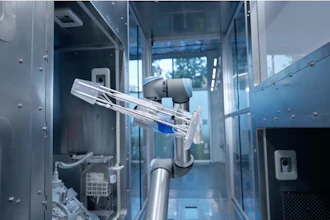 Interior view of robotic medical device with mechanical arm, tubing, and electronic components