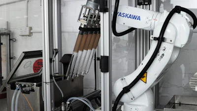 ASKAWA industrial robotic arm with tool changer mounted in manufacturing enclosure